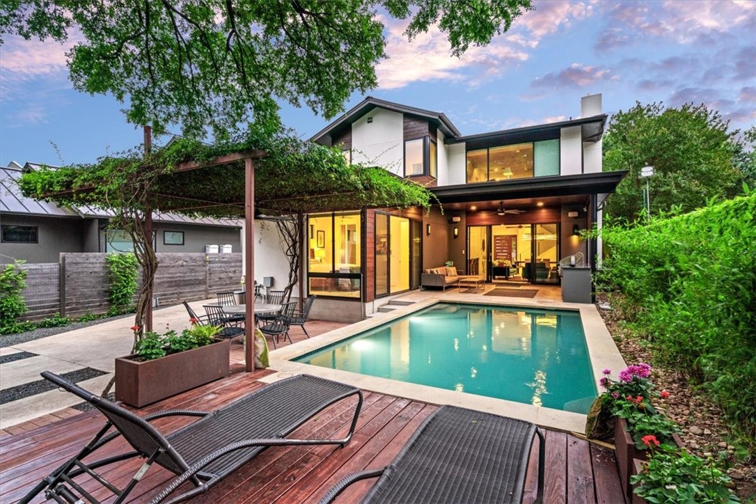 a view of a house with pool and chairs