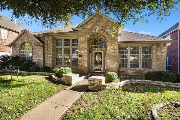 a front view of a house with swimming pool and porch