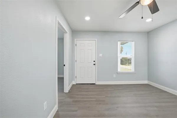 a view of a kitchen with a sink and dishwasher a refrigerator with wooden floor