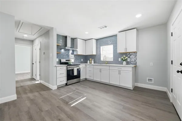 a kitchen with granite countertop a sink stainless steel appliances and cabinets