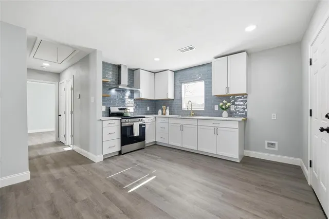 a kitchen with granite countertop a sink stainless steel appliances and cabinets