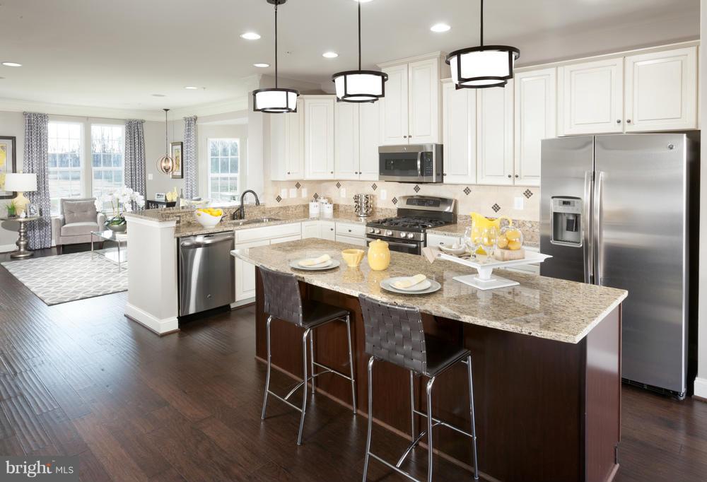7635 Telamon Way Hanover, MD 21076 - Photo 2 of 30 a kitchen with a dining table chairs stainless steel appliances and cabinets