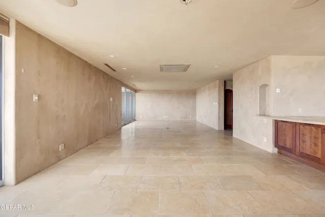 a kitchen with a wooden floor and a refrigerator