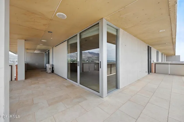 a view of a chandelier fan and entryway