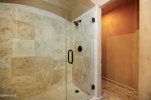 a patio with table and chairs and potted plants