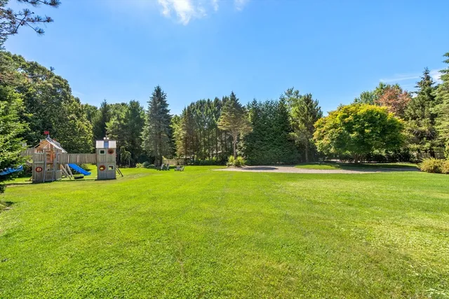 a view of a field of grass and trees