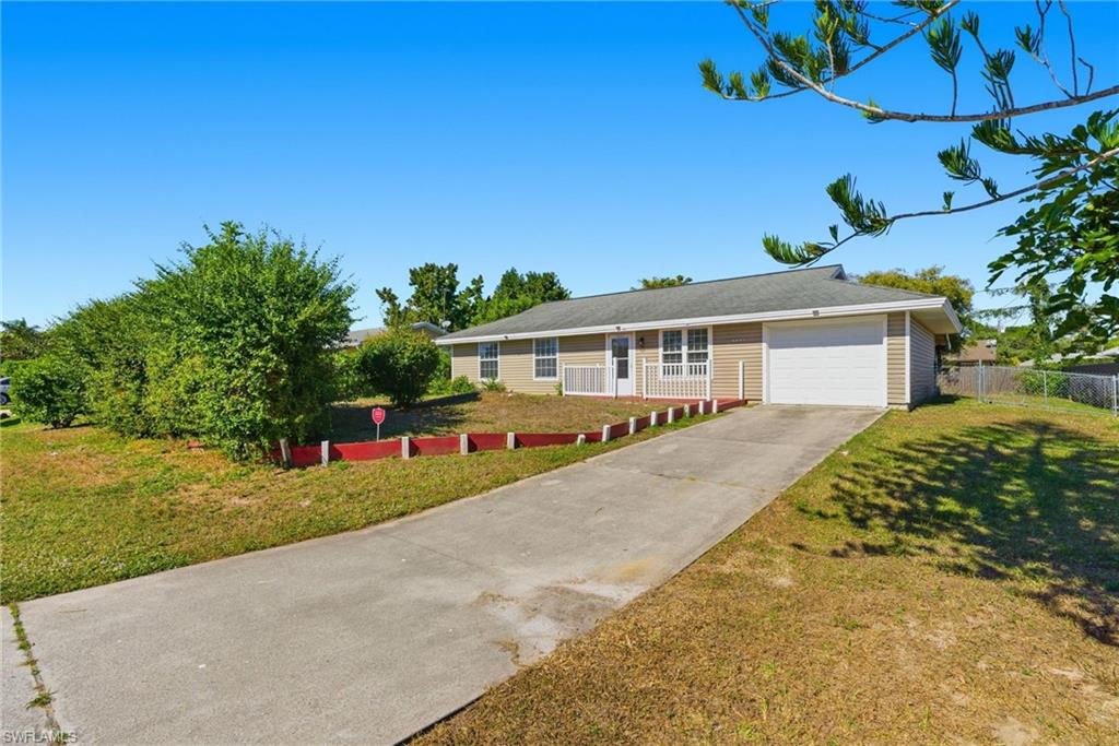 a view of a house with backyard and sitting area