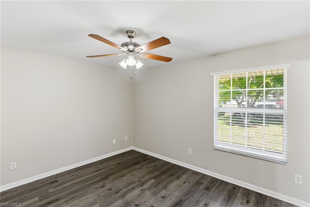 5283 17th Place Southwest Naples, FL 34116 - Photo 13 of 20 an empty room with wooden floor fan and windows
