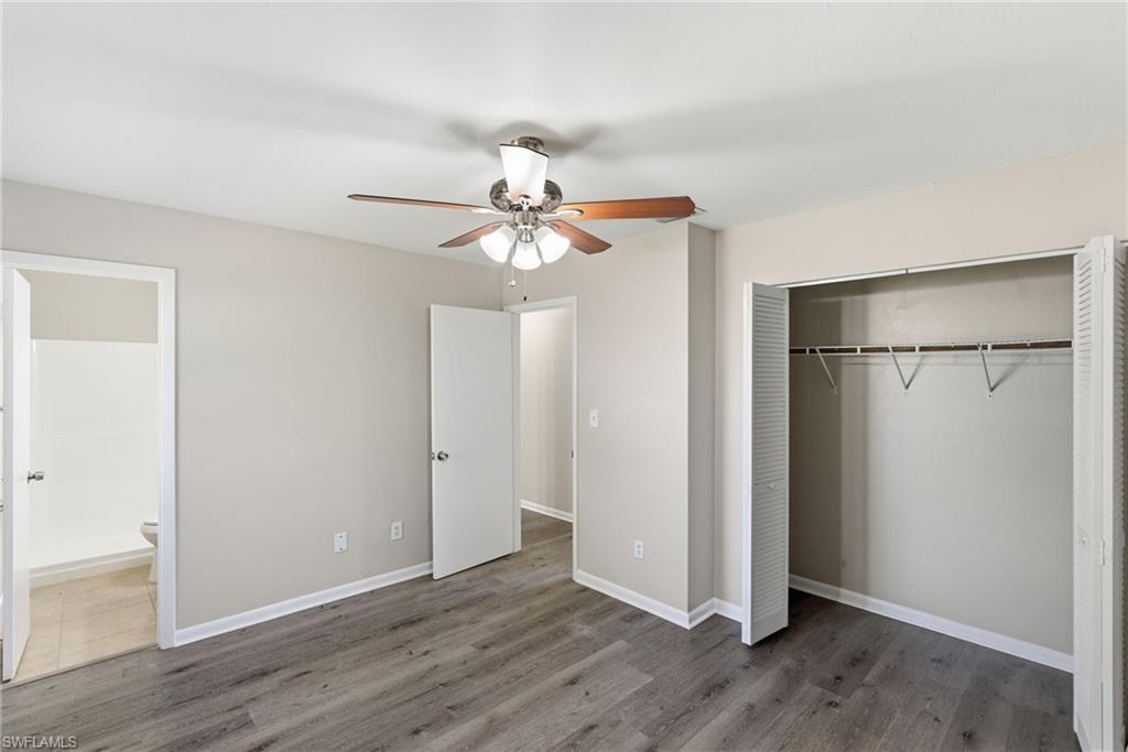 5283 17th Place Southwest Naples, FL 34116 - Photo 14 of 20 an empty room with wooden floor and fan