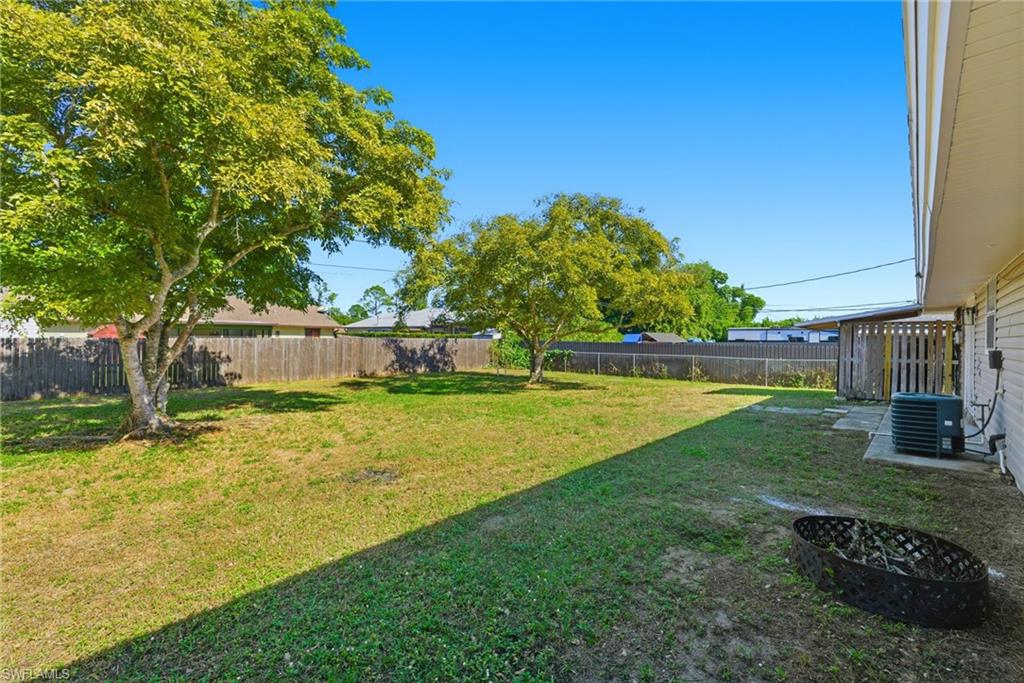5283 17th Place Southwest Naples, FL 34116 - Photo 18 of 20 a view of a swimming pool with a yard