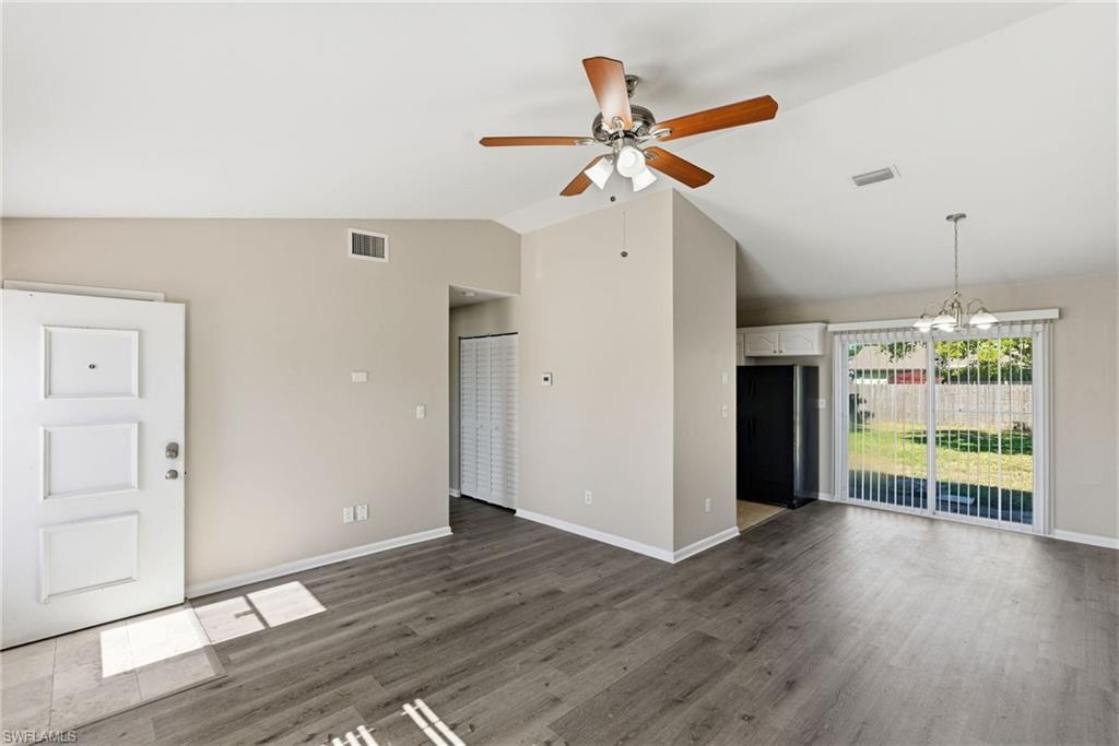 5283 17th Place Southwest Naples, FL 34116 - Photo 8 of 20 an empty room with wooden floor fan and windows