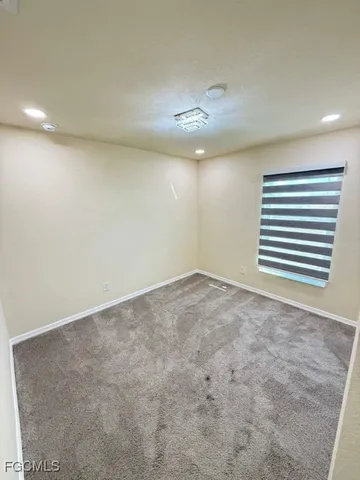 a bathroom with a granite countertop sink a toilet a mirror and shower