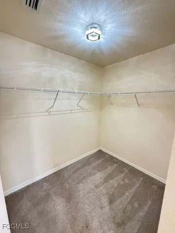 a bathroom with a granite countertop sink a toilet and a shower