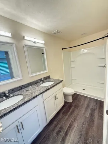 an empty room with a ceiling fan and window