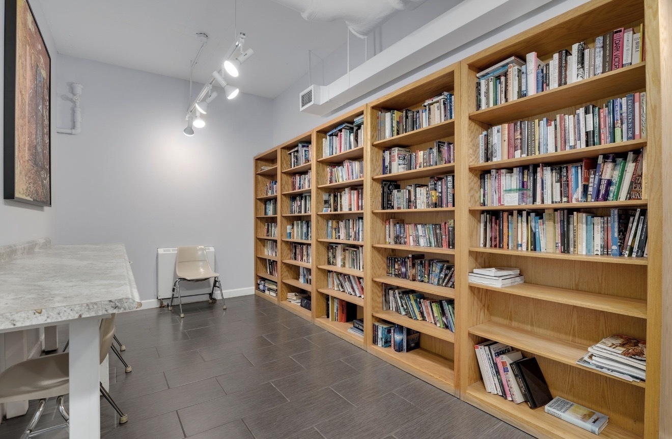 1550 North Lake Shore Drive, Unit 9F Chicago, IL 60610 - Photo 17 of 19 a view of a workspace with bookshelf