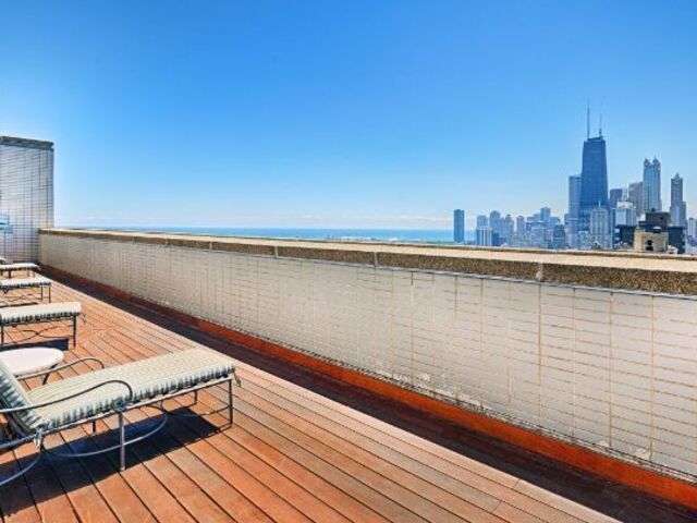 1550 North Lake Shore Drive, Unit 9F Chicago, IL 60610 - Photo 19 of 19 a view of roof deck with wooden floor and seating space