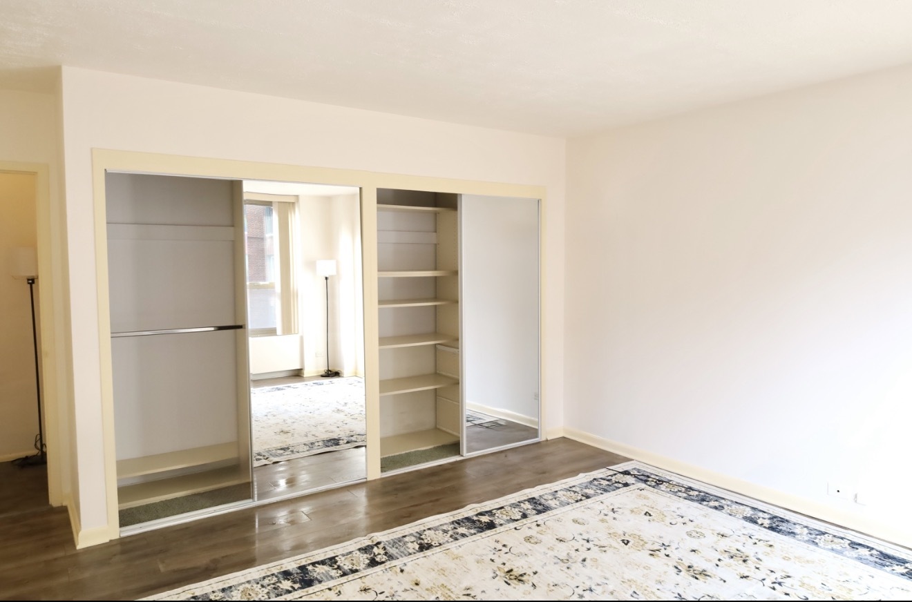 1550 North Lake Shore Drive, Unit 9F Chicago, IL 60610 - Photo 8 of 19 a view of a hallway with wooden floor and a living room
