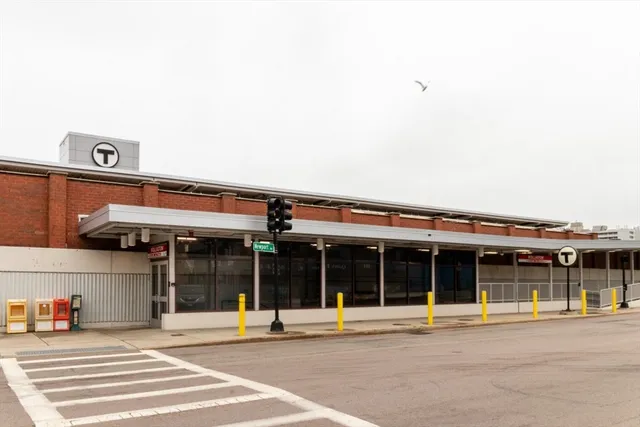 a view of a building with a window and a car parked