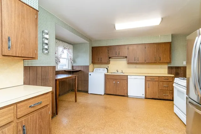 a kitchen with a stove a sink a microwave a counter top space and cabinets