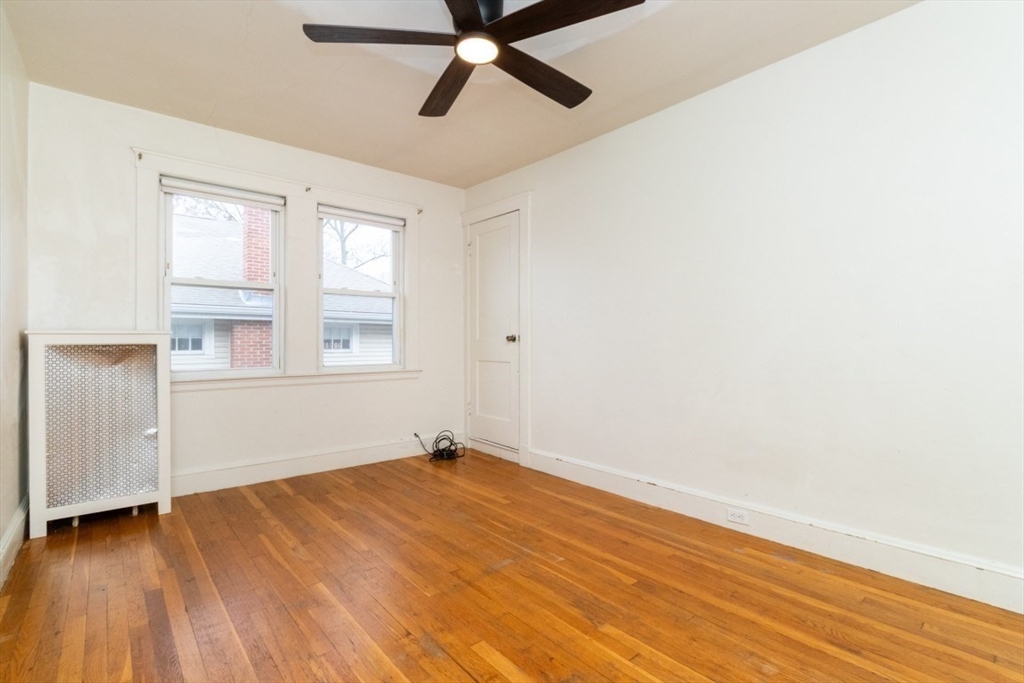 151 Pine Street, Unit 2 Quincy, MA 02170 - Photo 6 of 11 a view of empty room with wooden floor and fan