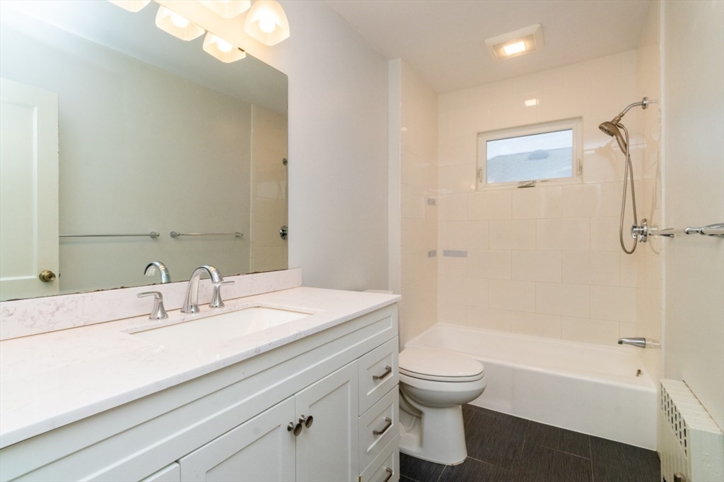 151 Pine Street, Unit 2 Quincy, MA 02170 - Photo 8 of 11 a bathroom with a sink a toilet and a bathtub