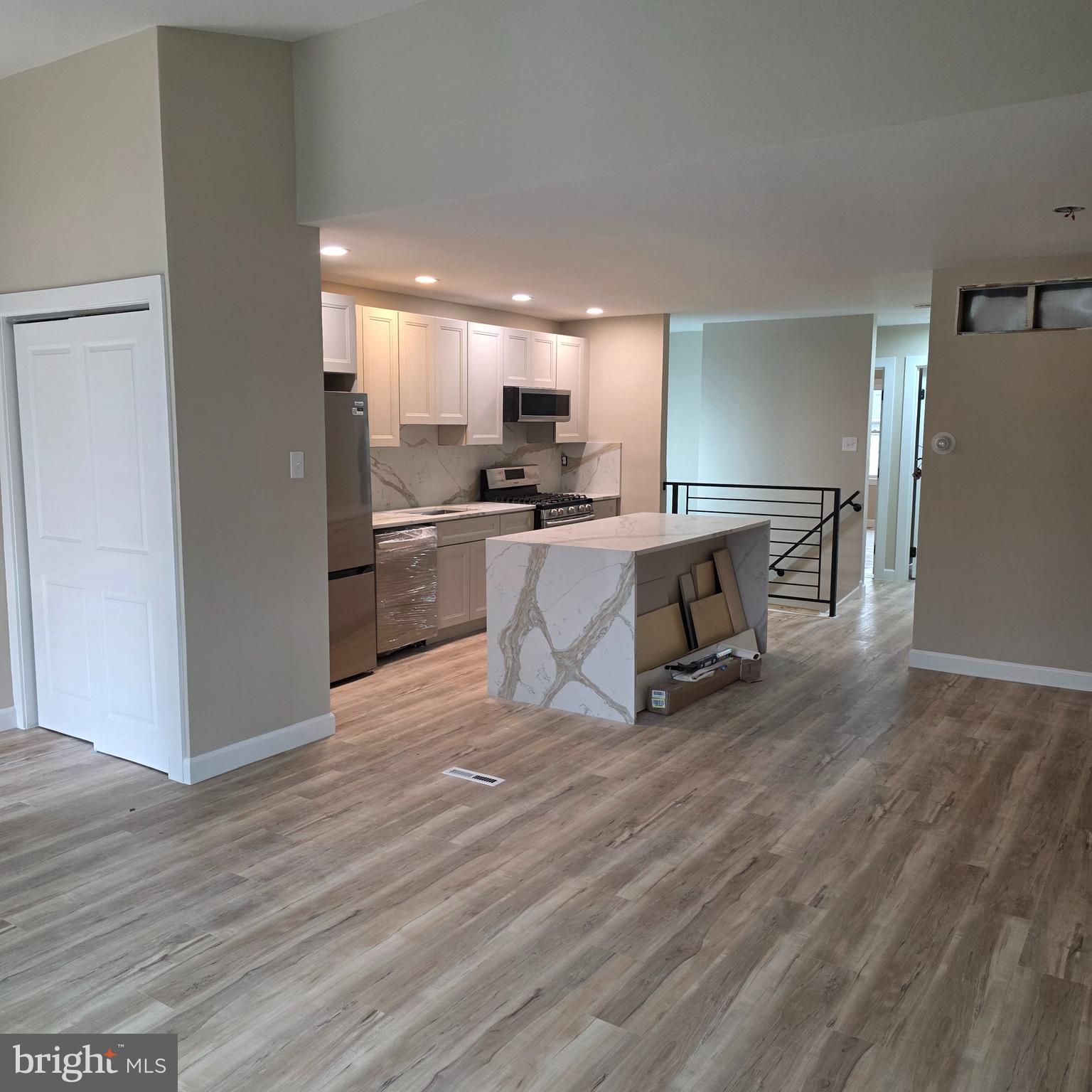 12702 Knights Road Philadelphia, PA 19154 - Photo 2 of 23 a kitchen with stainless steel appliances granite countertop a stove a refrigerator and a wooden floors