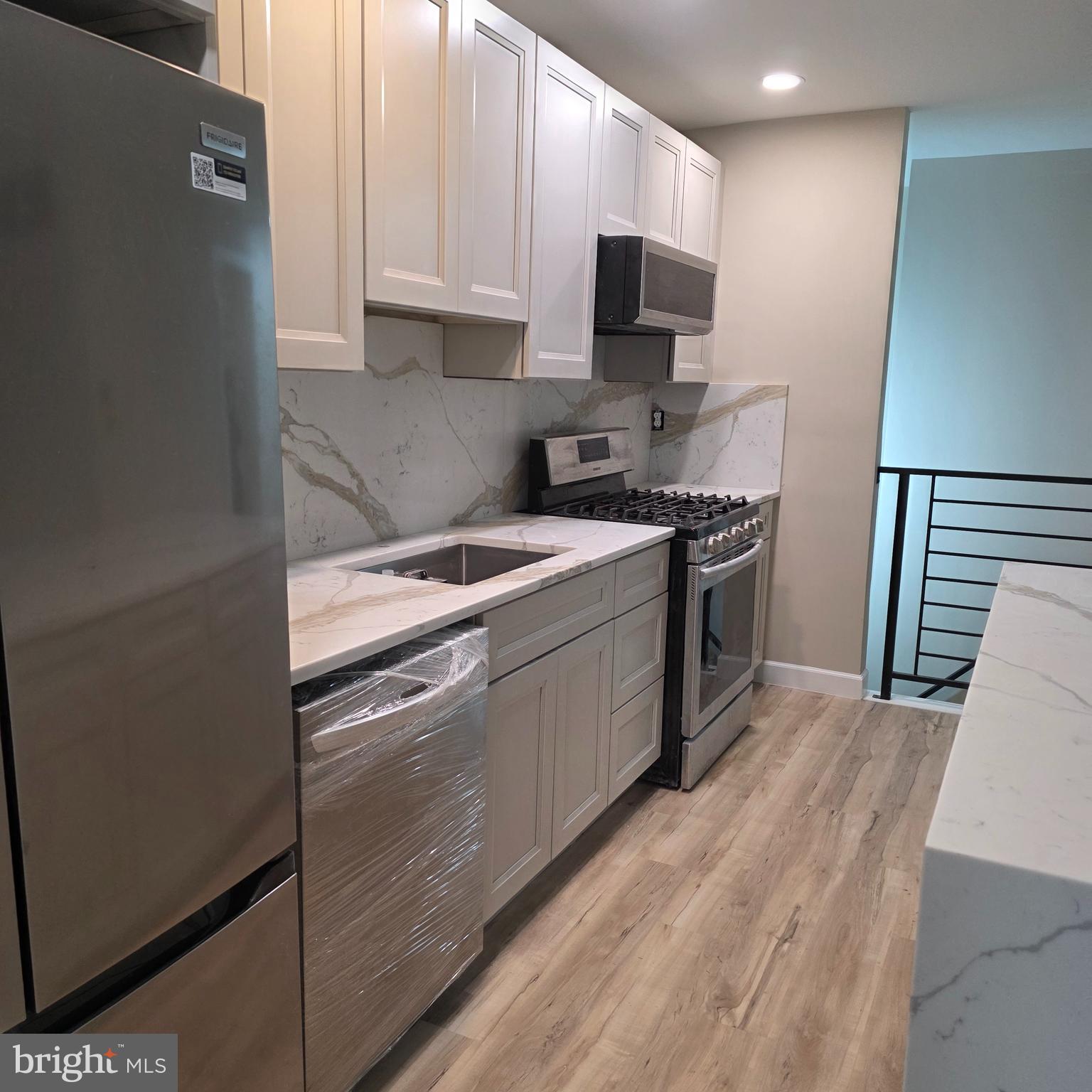 12702 Knights Road Philadelphia, PA 19154 - Photo 3 of 23 a kitchen with stainless steel appliances granite countertop a stove a sink and a refrigerator