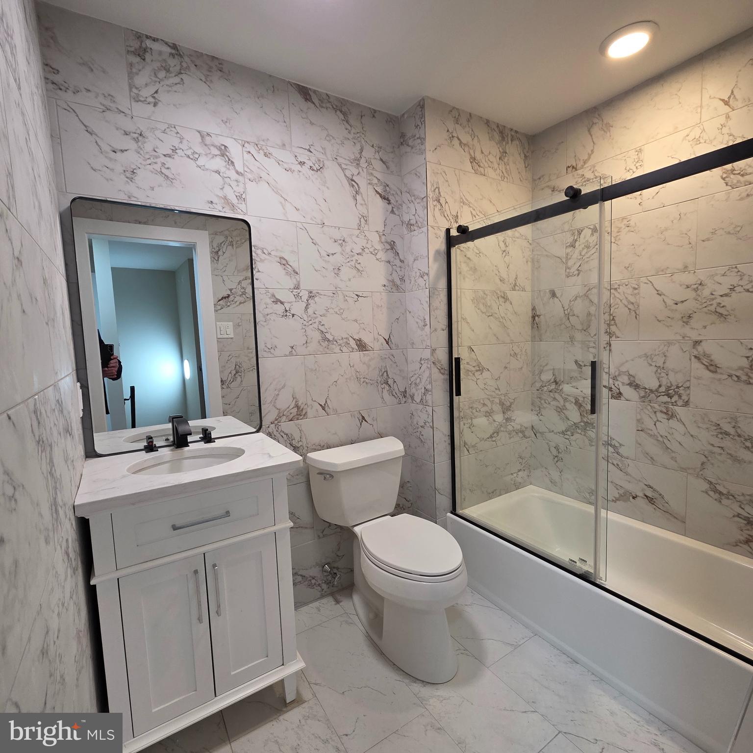 12702 Knights Road Philadelphia, PA 19154 - Photo 6 of 23 a bathroom with a sink a toilet and shower