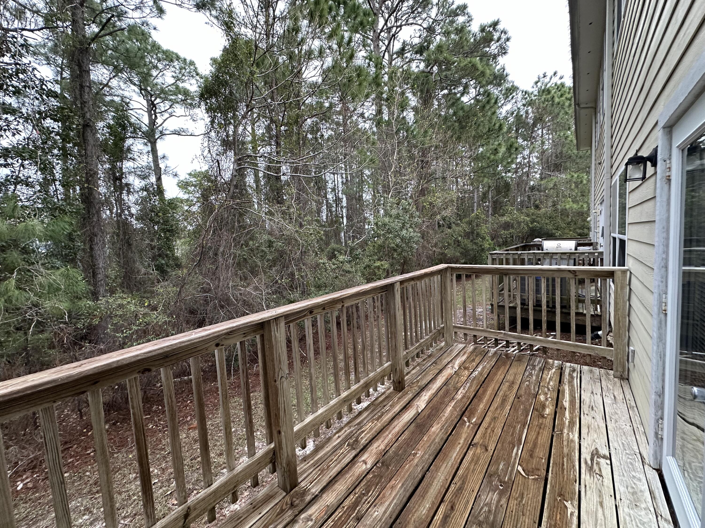 732 East Mack Bayou Drive, Unit 2 Santa Rosa Beach, FL 32459 - Photo 37 of 43 a view of balcony with wooden floor and fence
