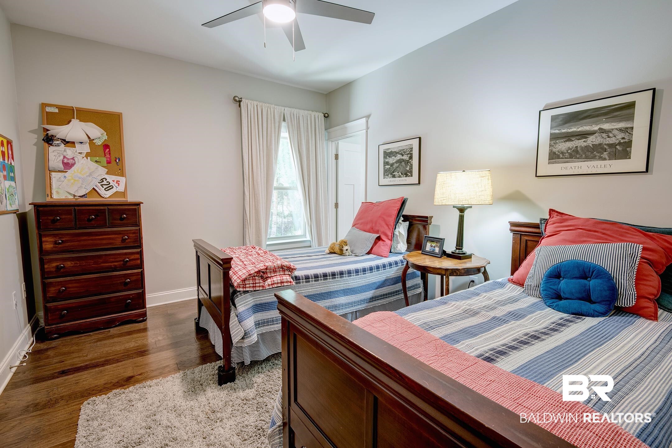18754 Treasure Oaks Road Gulf Shores, AL 36542 - Photo 35 of 53 Bedroom featuring wood-finish flooring, a ceiling fan with integrated lighting, and a window with neutral drapery