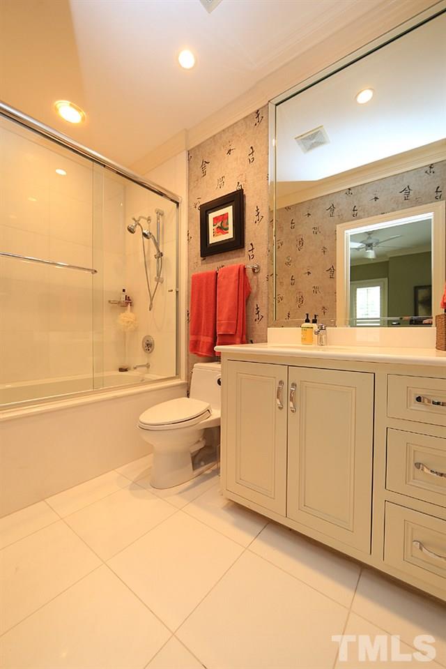 2023 Landings Way Raleigh, NC 27615 - Photo 16 of 25 a bathroom with a double vanity sink toilet mirror and shower
