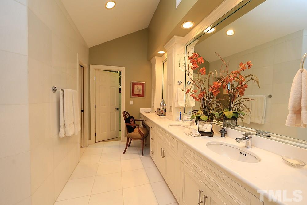 2023 Landings Way Raleigh, NC 27615 - Photo 19 of 25 a spacious bathroom with a double vanity sink a mirror and a shower