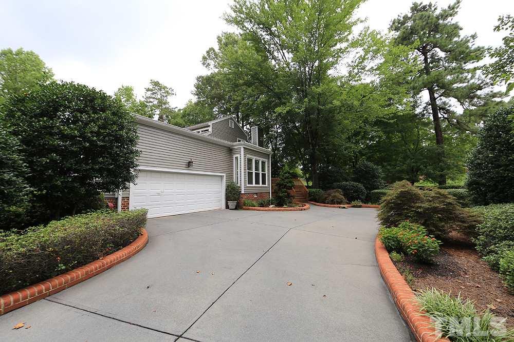 2023 Landings Way Raleigh, NC 27615 - Photo 22 of 25 a front view of a house with a yard and trees