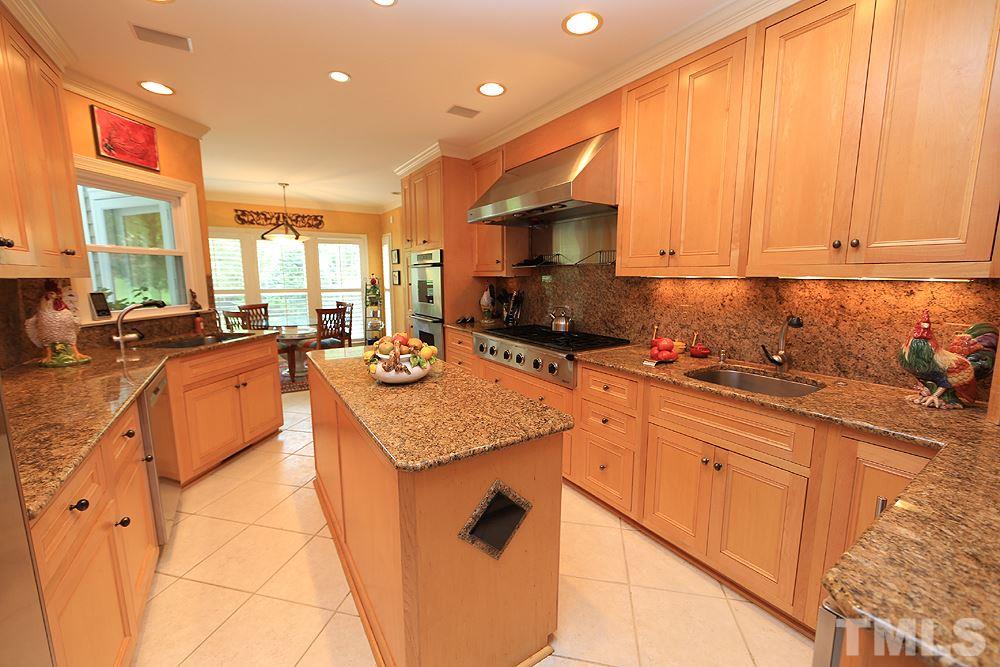 2023 Landings Way Raleigh, NC 27615 - Photo 4 of 25 a kitchen with stainless steel appliances granite countertop sink stove and cabinets