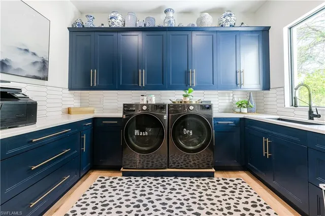 a kitchen with a sink a stove and cabinets