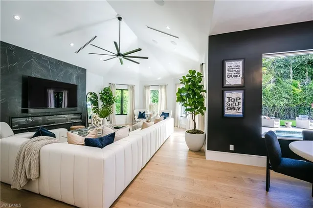 a living room with furniture fireplace and window