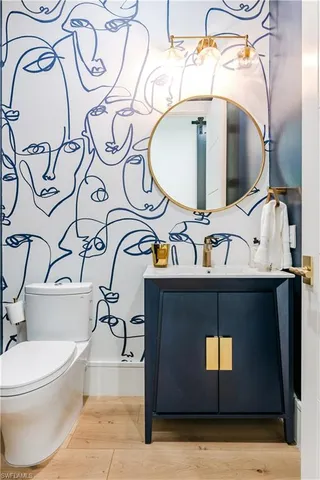 a bathroom with a toilet sink and mirror