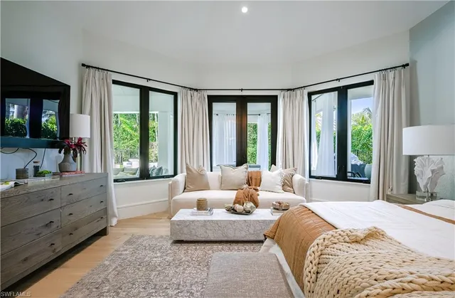 a spacious bedroom with a large bed and a large window