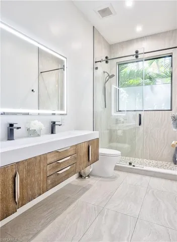 a bathroom with a tub sink and mirror
