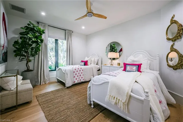 a bedroom with a bed couch and window