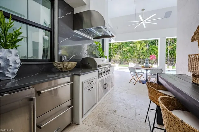 a open kitchen with a table chairs and a stove