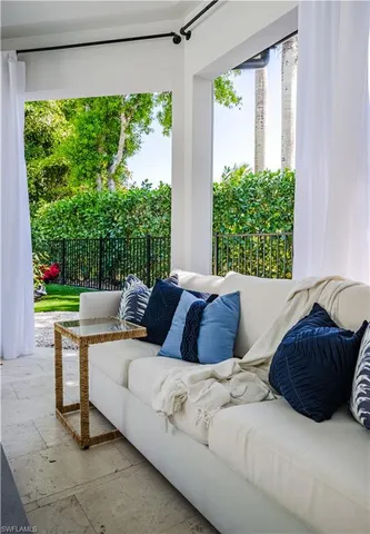a living room with a bed furniture and a large window