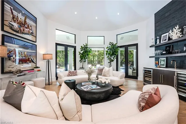 a living room with furniture and a floor to ceiling window