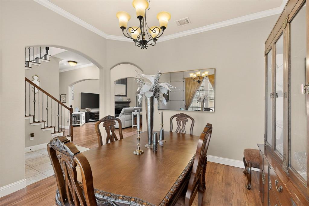 3608 Bright Star Way Plano, TX 75074 - Photo 13 of 40 a view of a dining room with furniture a chandelier and wooden floor