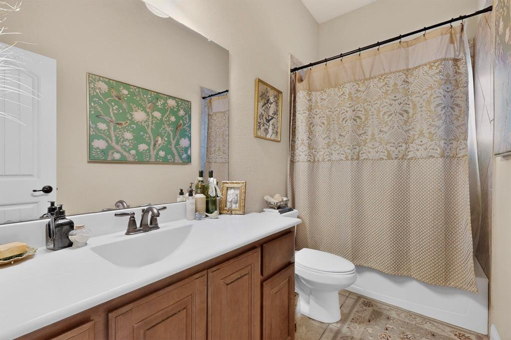 3608 Bright Star Way Plano, TX 75074 - Photo 16 of 40 a bathroom with a sink a toilet and a mirror