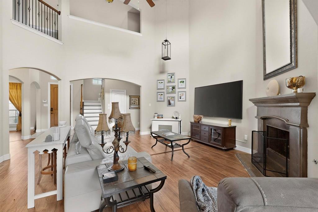 3608 Bright Star Way Plano, TX 75074 - Photo 6 of 40 a living room with furniture a flat screen tv and a fireplace