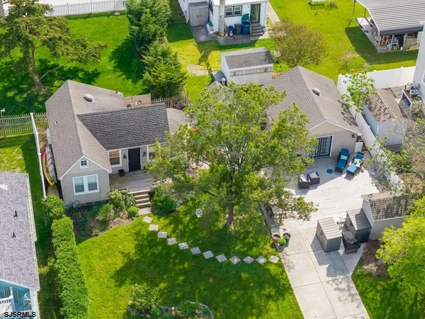 an aerial view of multiple houses with yard