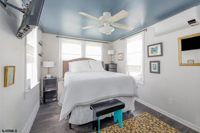a bedroom with a bed and a table with wooden floor