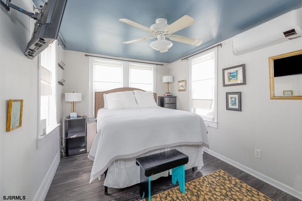 100 Decatur Avenue Somers Point, NJ 08244 - Photo 12 of 52 a bedroom with a bed and a table with wooden floor