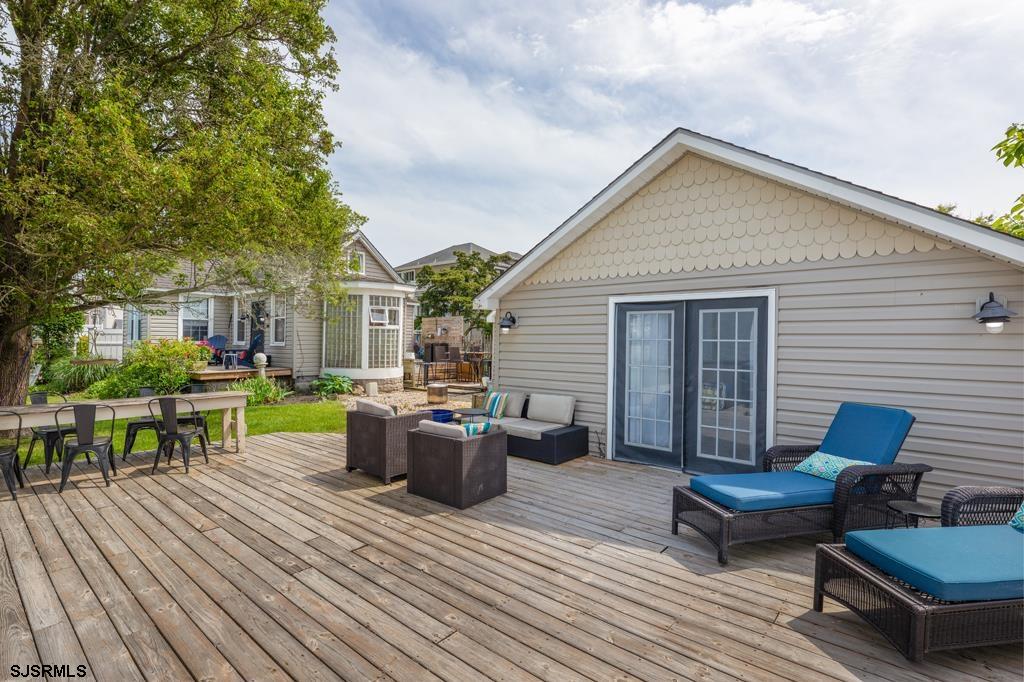 100 Decatur Avenue Somers Point, NJ 08244 - Photo 14 of 52 a view of a patio with couches chairs and wooden floor